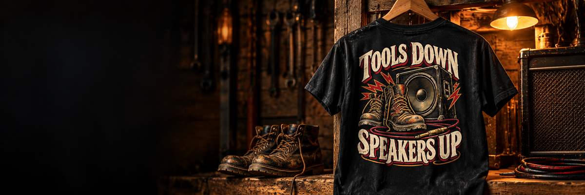 Clock Off & Crank Up collection: original back-print tees in hanging tee in authentic timber workshop with work boots and speaker