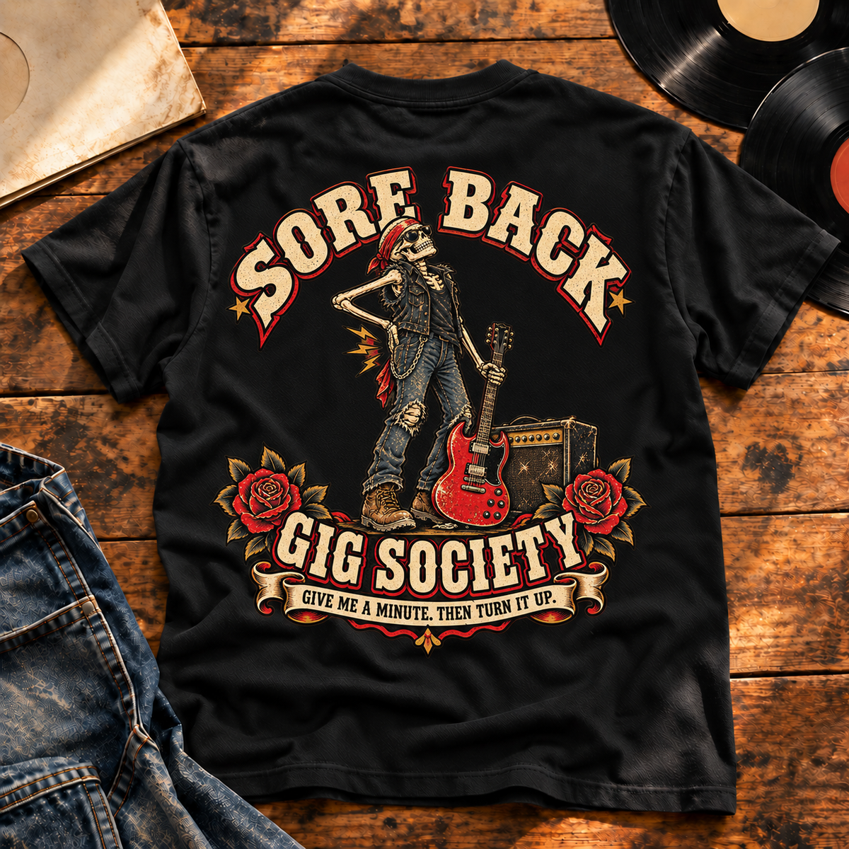 Sore Back Gig Society Heavyweight Tee — Black back print in vintage vinyl flat-lay setting