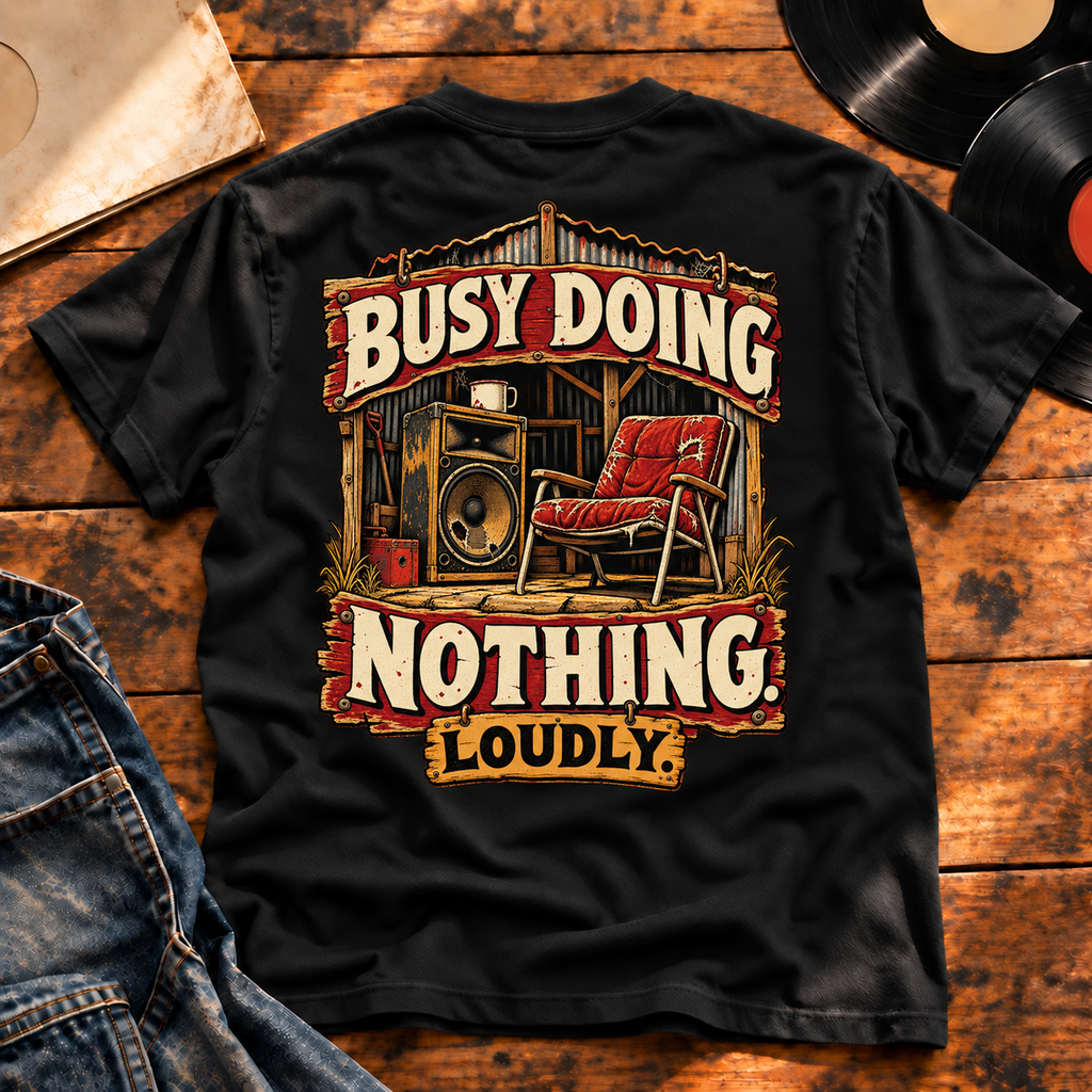 Busy Doing Nothing Loudly Heavyweight Tee — Black back print flat-lay hero