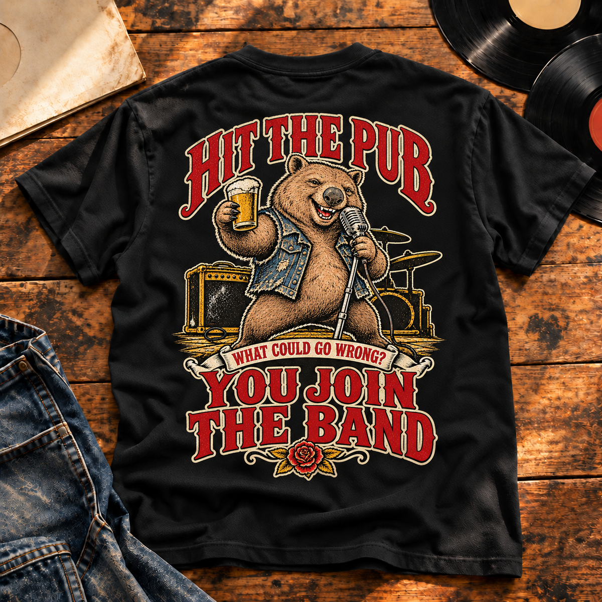 Hit the Pub heavyweight tee back print — vinyl flatlay hero