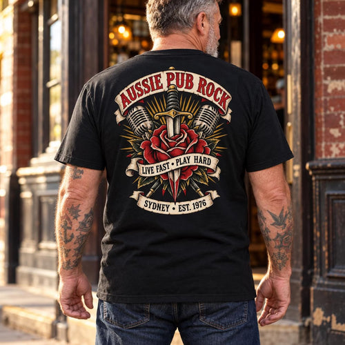 Man wearing the black Australian Pub Rock rose and dagger T-shirt, showing the back print outside a pub