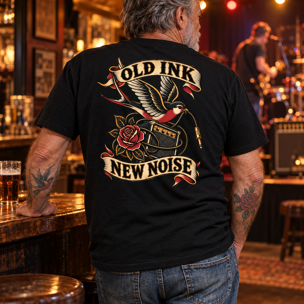 Tattooed pub-rock fan wearing Old Ink, New Noise back print tee