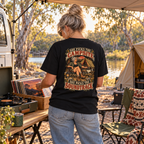 She Picks the Campsite She Picks the Soundtrack Heavyweight Tee — Black lifestyle photograph