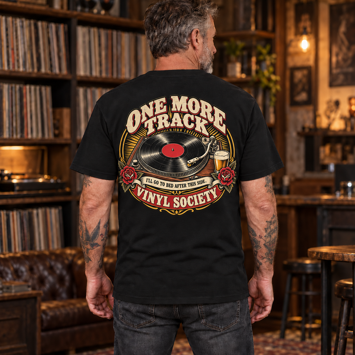 One More Track Vinyl Society Heavyweight Tee — mature model wearing Black back print