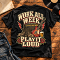 Work All Week Play It Loud heavyweight tee with guitar, boots and amp back print on a wooden table with vinyl records